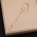 Exquisite gold-tone finger bracelet featuring colorful cubic zirconia clover and round stones. - Style 1
