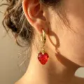Gold hoop earrings with red acrylic strawberry pendant, stylish detail jewellery piece. - Red