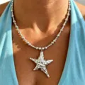 Close-up detail of the stainless steel irregular star pendant and beaded necklace. - Silver