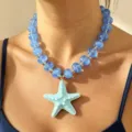 Close-up detail shot of vibrant blue acrylic beaded necklace featuring a turquoise starfish pendant. - Blue Bead