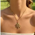 Close-up view of the chic gold stainless steel paperclip chain with a sun spiral pendant. - Gold