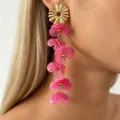 Long pink resin flower drop earrings featuring a gold sunburst stud for a sweet style detail. - Rose Red