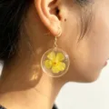 Elegant resin dried yellow flower earrings with gold-tone metal trim and hook for daily wear. - Size 9