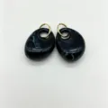 Detailed view of black marble resin earrings, elegant geometric gold ring drop design. - Black and White Marble