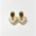 Detailed view of fashionable resin heart earrings with vintage gold stainless steel studs. - Milky White