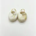 Closeup detail of retro geometric resin earrings with stainless steel rings, elegant style. - Oval Resin Style
