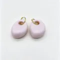 Detailed shot of light pink geometric resin and stainless steel earrings with gold rings, minimalist. - Light Pink