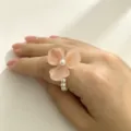 Close-up detail shot of the pink resin flower ring featuring a pearl center and bead band. - 4#