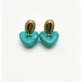 Detailed shot of trendy turquoise marble resin heart earrings with gold metal stud top component. - Blue