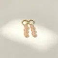 Chic gold hoop earrings featuring elegant dangling peach natural stone round beads detail view. - No.3 Gold