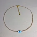 Detailed view of dainty beaded necklace with blue evil eye pendant and gold adjustable chain. - 4#