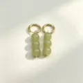 Detailed close-up view of elegant gold hoop earrings featuring hanging green round drops. - 7# Gold