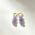 Close-up detail shot of elegant gold hoop earrings featuring vertical purple beaded drops. - 8# Gold