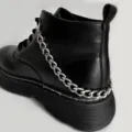 Detailed view of black platform combat boots featuring a chunky silver chain accessory. - Single Layer Aluminum Shoe Chain / Silver