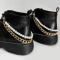 Detailed view of black Martin boots with stylish double layer gold chain and pearl shoe accessories. - Pearl Double Layer Aluminum Shoe Chain / Gold