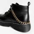 Black Martin boots detail featuring a stylish gold chain accessory for trendy footwear decor. - Single Layer Aluminum Shoe Chain / Gold