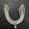 Close-up detail of multi-layer imitation pearl necklace with gold extension chain and pendant. - Gold