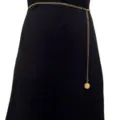 Gold metal waist chain detail showing the delicate single layer link and smooth round pendant. - Gold