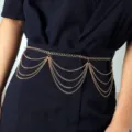 Close-up of multi-layer gold metal waist chain, elegant draped chain accessory details. - Tassel Waist Chain / Gold
