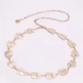 Close-up detail view of the elegant gold leaf metal waist chain, delicate design for women. - 14 Leaves Waist Chain / Gold