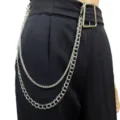 Detail shot of a stylish double layer silver metal pant chain worn on black trousers for a punk gothic look. - Snake Bone Chain + Double Weave Chain / White K/Silver