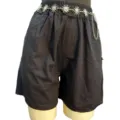 Detailed view of women black shorts accessorized with a metallic sun motif waist chain fashion. - Sun Pendant Style / 15 Pieces/Pack / White K/Silver