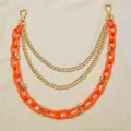 Details of the multi-layer punk hip-hop orange resin and gold metal chain accessory. - Trousers Chains (Orange)