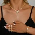 Detail view of sparkling zirconia flower necklace, earrings, ring and bracelet set. - 4-Piece Set (HB094-2) / Gold
