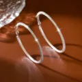 Dettaglio di orecchini a cerchio scintillanti in cristallo, grande design circolare argentato. - 6.50cm / Argento
