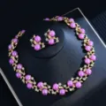 Detailed view of the luxury purple pearl necklace and earrings set with gold-plated details. - Purple Pearl Set
