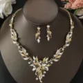 Vista dettagliata di uno splendido set di collana e orecchini da sposa con strass oro. - Set Foglia Fiore Deluxe (80804502)