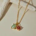 Detail shot of a gold-plated O-chain necklace featuring dual green and red stone pendants. - Green Oval Red Round Gemstone Style (KN0691) / 1 Piece