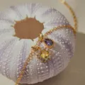 Gold-plated delicate necklace featuring purple pear and yellow sun gemstone charms. - Purple Drop Yellow Flower Zirconia Style (KN0699) / 1 Piece