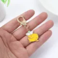 Cute cartoon yellow duck keychain pendant with white flower hat, gold metal keyring accessory. - Flower Hat Duck