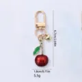 Cute cherry metal keychain charm with rhinestones, red enamel fruit bag pendant. - Long-stemmed Cherry