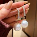 Elegant gold hoop earrings with sparkling stones and dangling white pearls for daily wear. - 4202 Gold & White