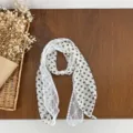 Detail view of vintage lace spliced silk scarf with elegant pearl decor for women spring style. - Beige