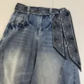 Classic blue denim jeans paired with a stylish black and white paisley print ribbon belt. - Border Paisley / 140x7cm / Black