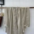 Detail shot of elegant women lightweight lace edge scarf shawl solid color stylish accessory - Beige