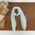 Chic light green lace patchwork silk scarf with delicate white lace trim and pearl brooch detail. - Light Green