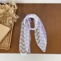 Floral lace scarf detail showing purple floral print, white lace trim and pearl clasp. - HMS - Star Fragment Purple