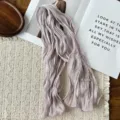 Close-up detail of a soft pleated long scarf in light purple, showcasing delicate texture. - Light Purple