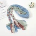 Detailed view of the multi-color braided pleated headscarf and sun protection travel scarf. - Light Blue Green Coffee