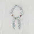 Detailed view of vintage floral fabric scarf necklace with natural wooden and stone beads decoration. - Plain Small Floral White