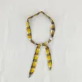 Detail view of yellow brown plaid fabric scarf necklace with charming wooden bead accents. - Plaid Yellow