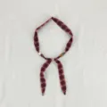 Detail shot of retro plaid fabric scarf necklace with beads, showing unique artisanal design. - Plaid Brick Red