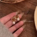 Detail view of retro autumn maillard amber and pearl earrings, minimalist elegant jewelry design. - Amber Color Pearl Stud Earrings