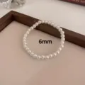 Elegante variante de pulsera de perlas de 6 mm con cuentas blancas en cordón elástico. - 6mm / Blanco