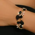 Bracciale in lega dorata con pietre nere a goccia e strass scintillanti per le donne. - Oro Nero