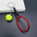 Red tennis racket keychain with mini ball pendant, perfect sports gift for tennis fans. - Red